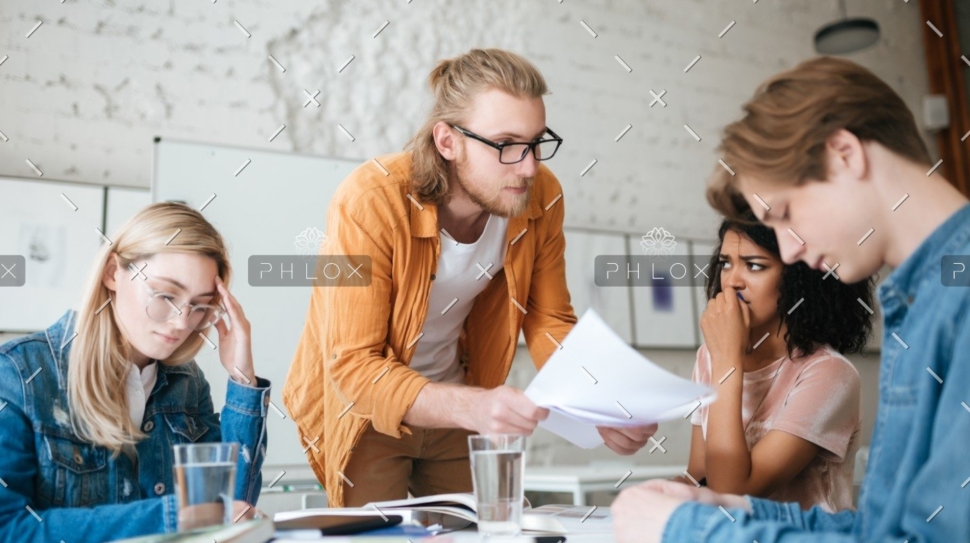 demo-attachment-292-group-of-upset-students-sitting-at-the-table-with-E5YW9L4